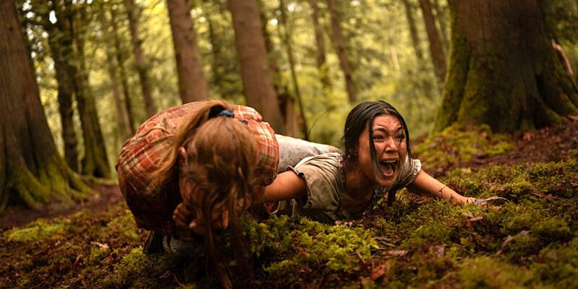 Shauna bites Mari while they fight on the ground in the forest in Yellowjackets season 3