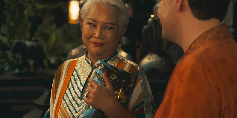 Sritala smiling at the hotel's manager in The White Lotus season 3 (2025)