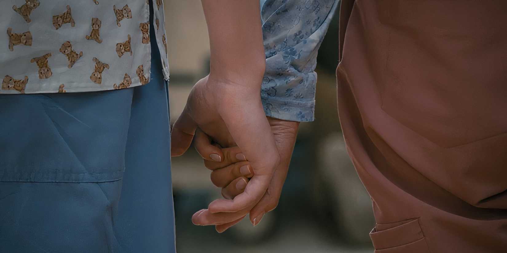 Mekki Leeper as Matt and Kahyun Kim as Serena holding hands in St. Denis Medical episode 9