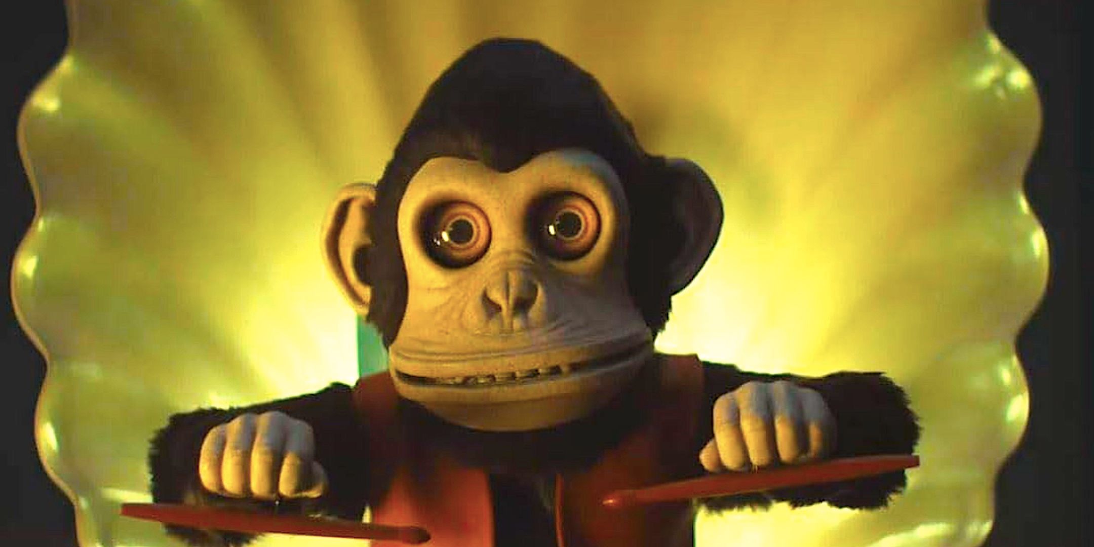 The monkey stares with its drumsticks raised in The Monkey 2025