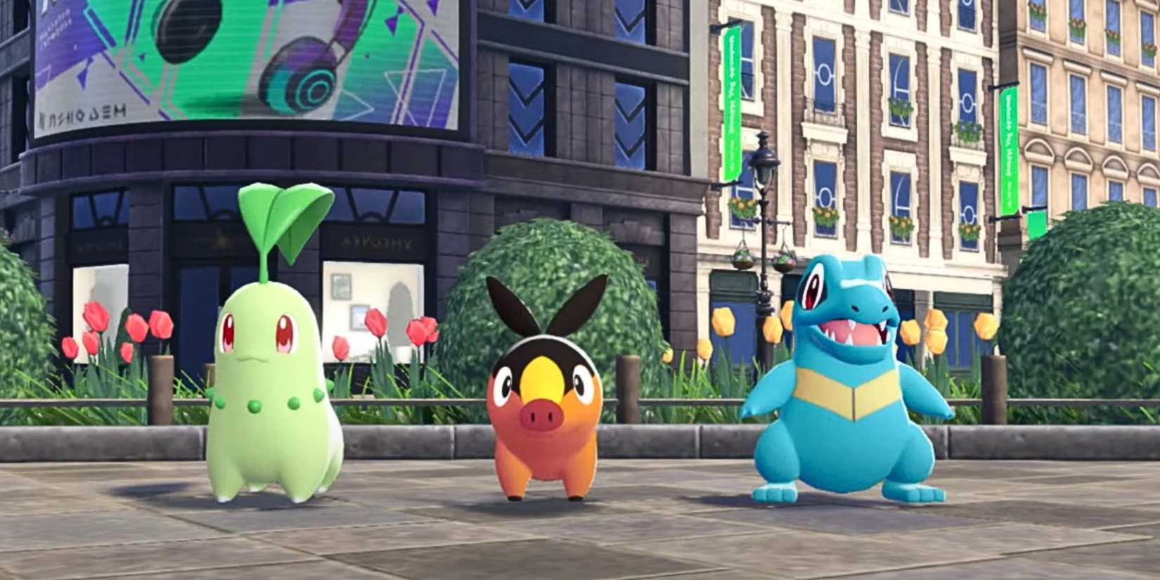 The three starting Pokemon in Pokemon Legends Z-A stand next to each other in a line. From left to right, there is Chikorita, Tepig and Totodile.
