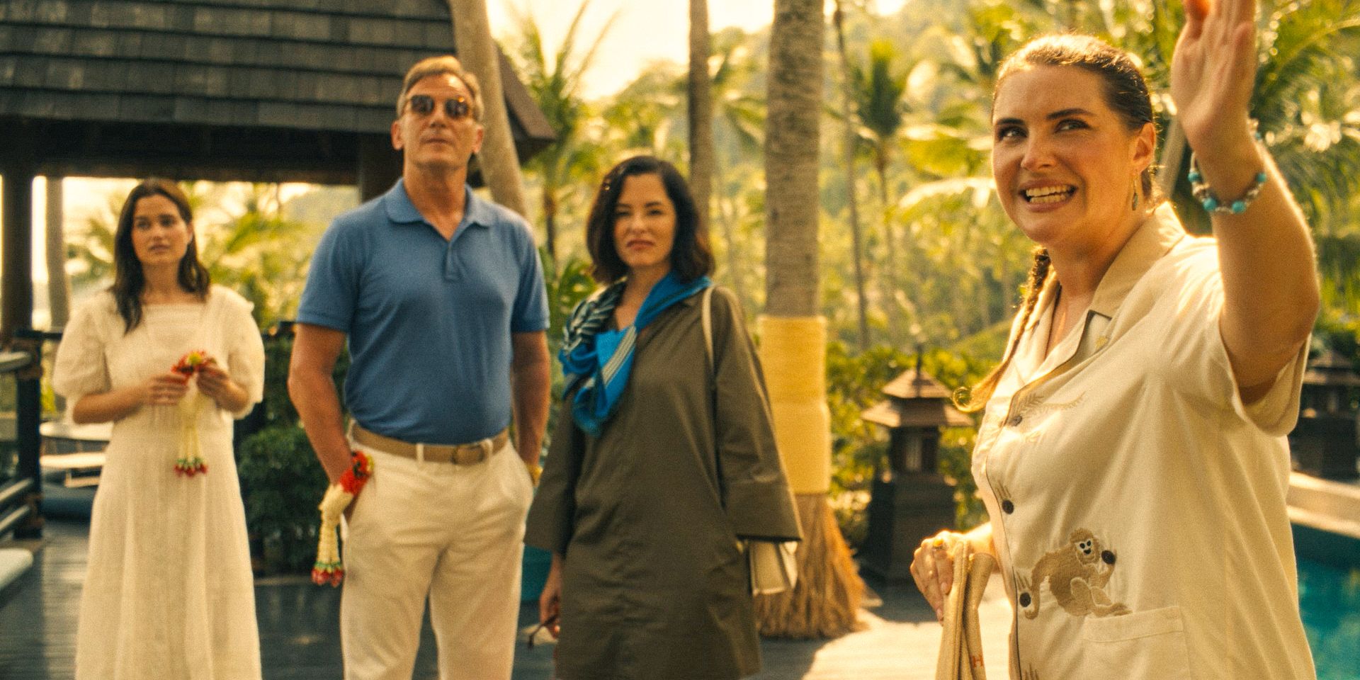 A concierge showing the Ratliff family a luxurious villa in The White Lotus Season 3 Ep 1