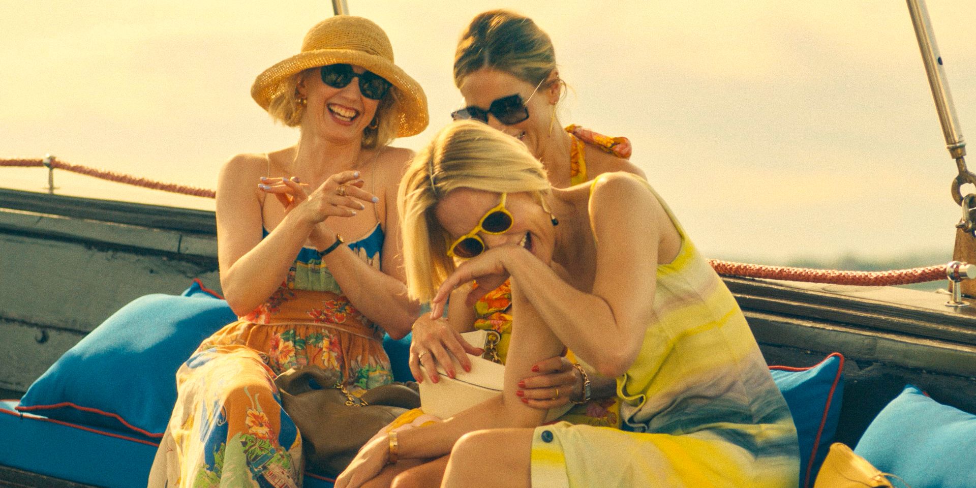 Laurie (Carrie Coon), Jaclyn Lemon (Michelle Monaghan), and Kate (Leslie Bibb) having fun on the boat on their way to the hotel in The White Lotus Season 3 Ep 1