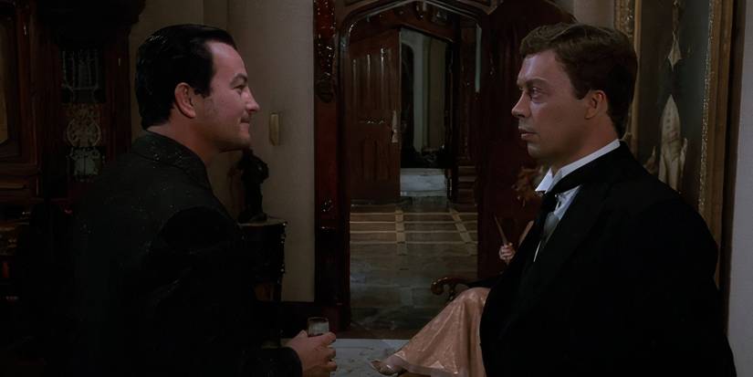 Tim Curry as Wadsworth talking to Lee Ving as Mr Boddy in Clue