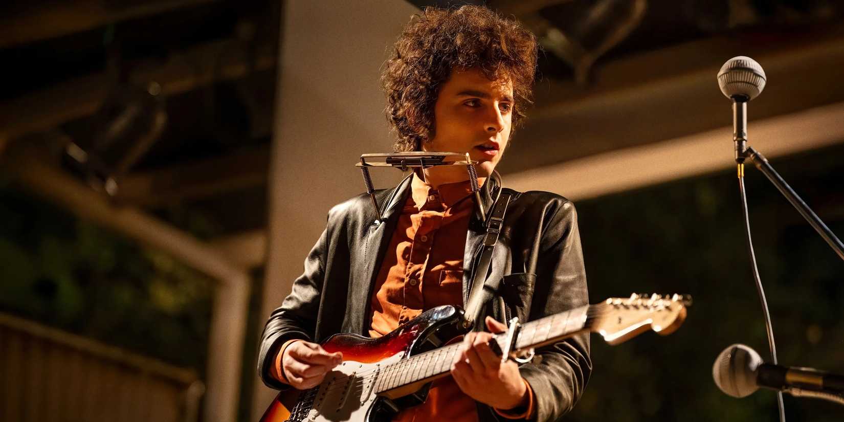 Timothee Chalamet playing an electric guitar in A Complete Unknown