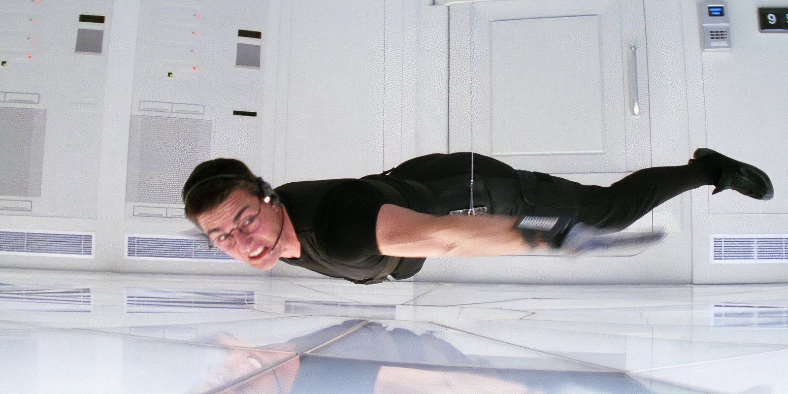 Tom Cruise dangles from wires as Ethan Hunt in Mission Impossible