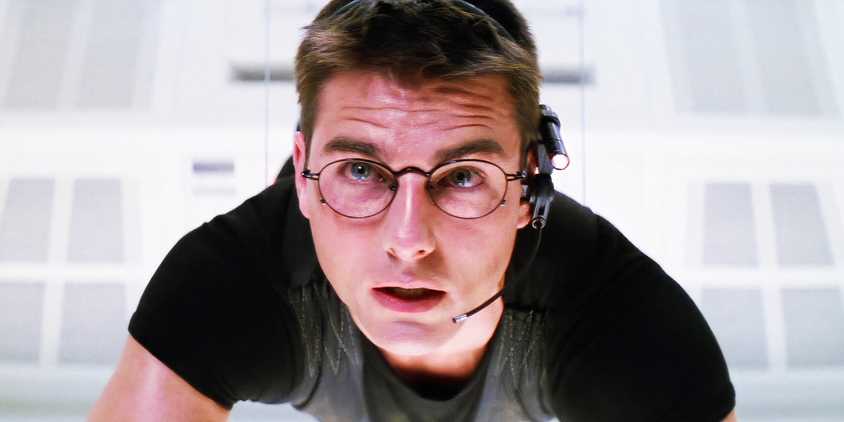 Tom Cruise in a white room dangling from a wire in Mission Impossible