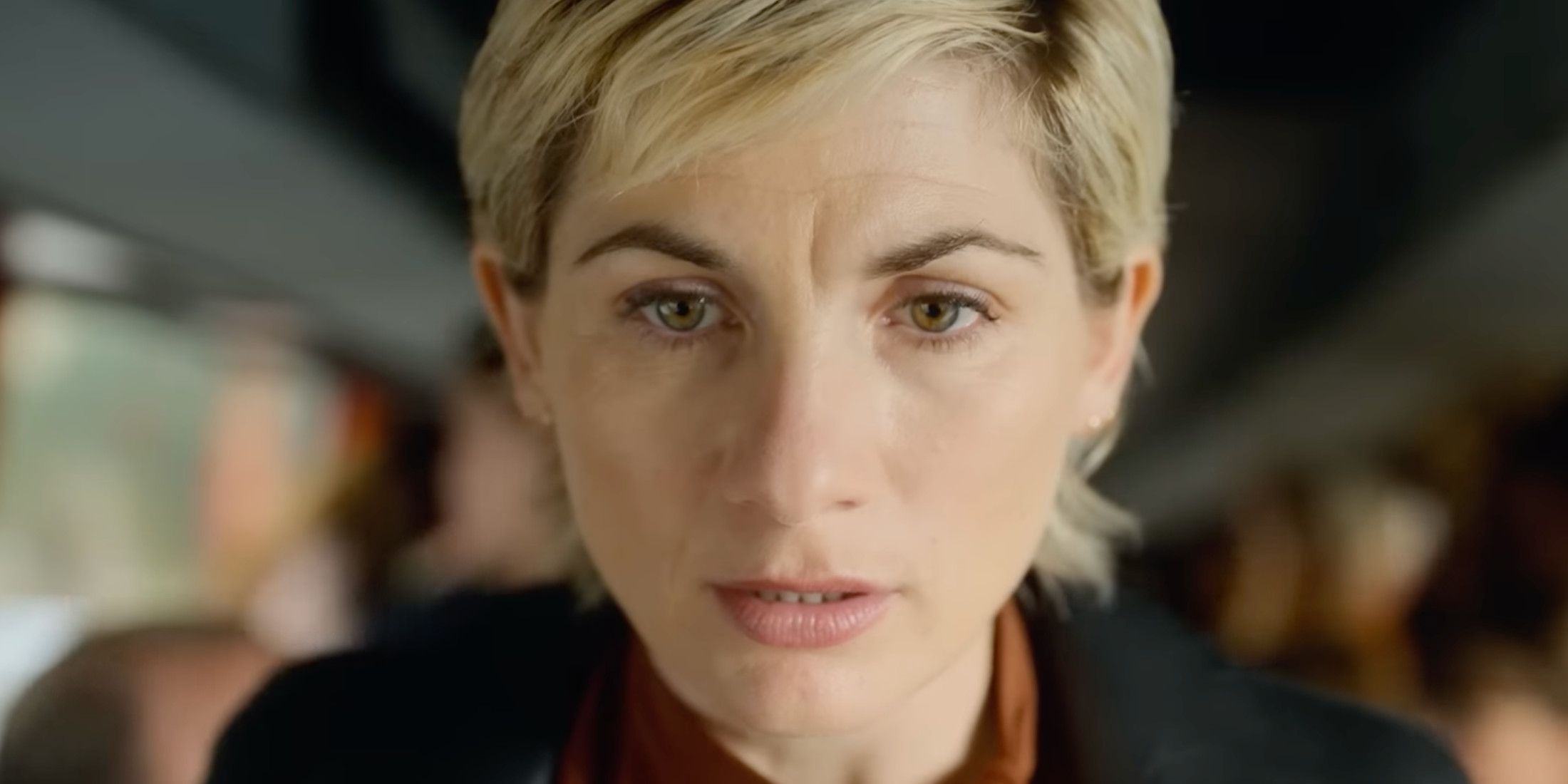 Toxic Town Jodie Whittaker standing on a bus looking very concerned 