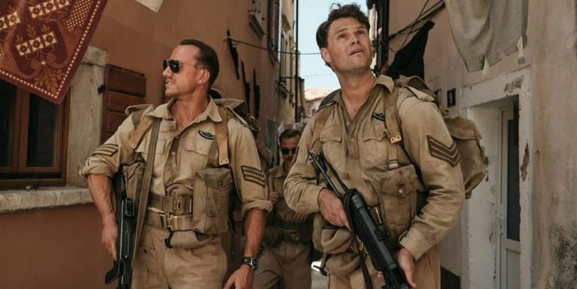 Two SAS soldiers walking through a tight street in SAS Rogue Heroes.