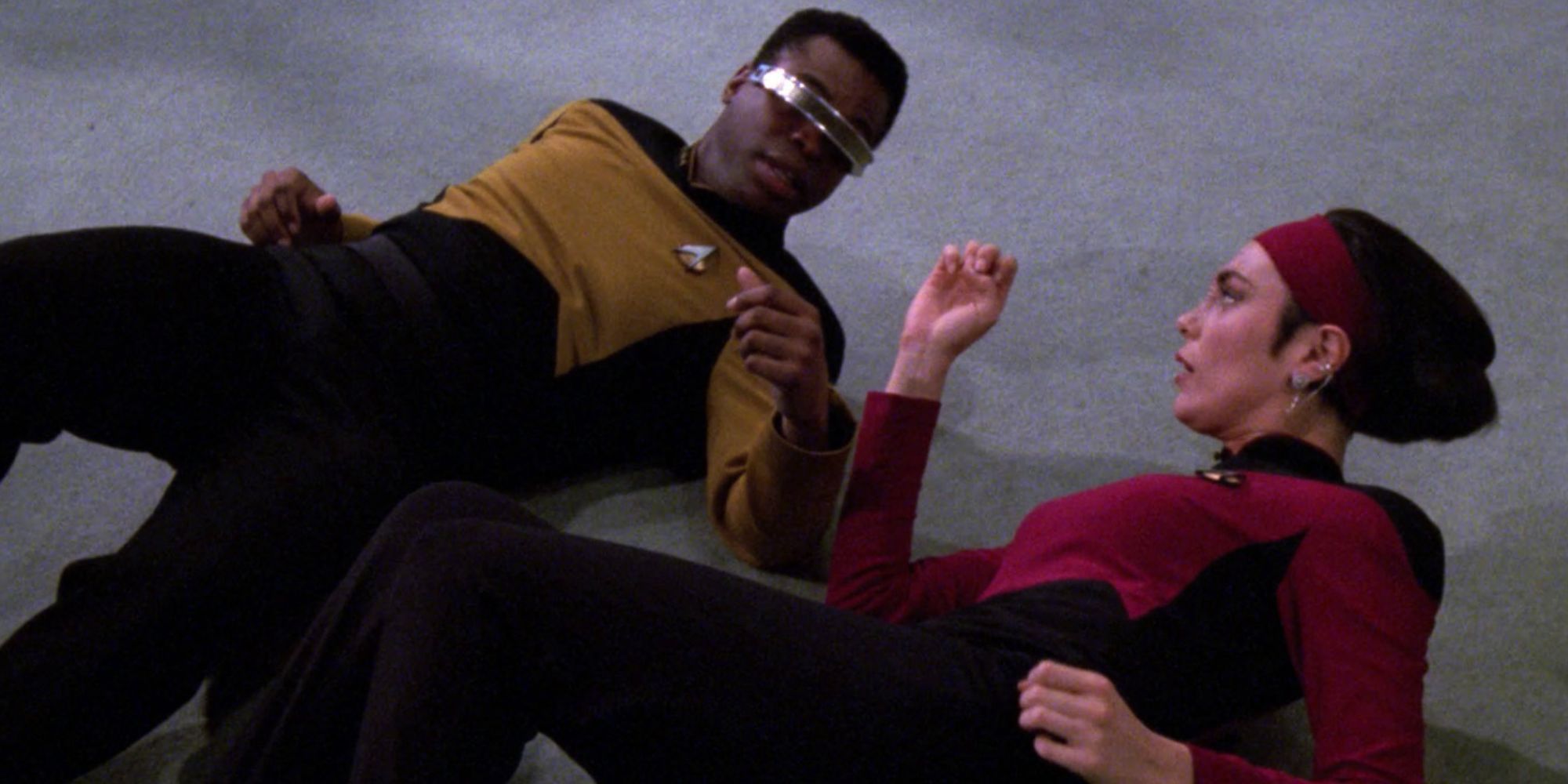 Geordie La Forge and Ro Laren on the ground in Star Trek: The Next Generation