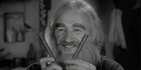 Gene Hackman holding two sticks and smiling in Young Frankenstein