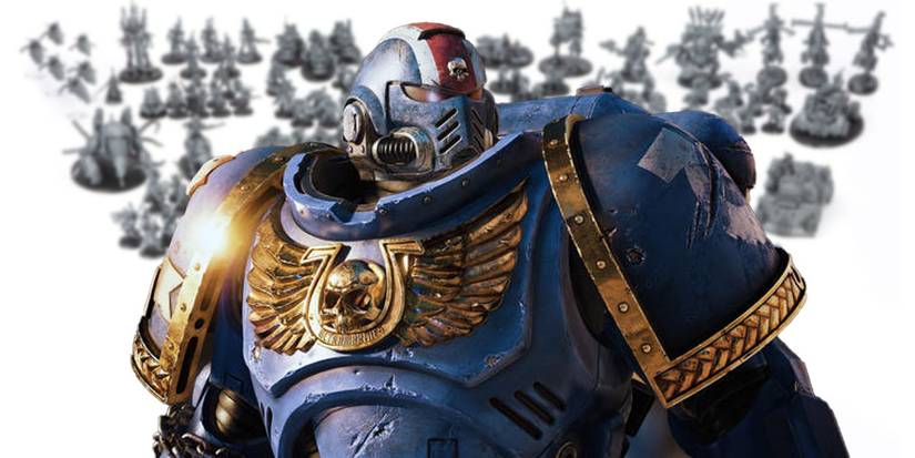 A Space Marine standing in front of blurred out miniatures