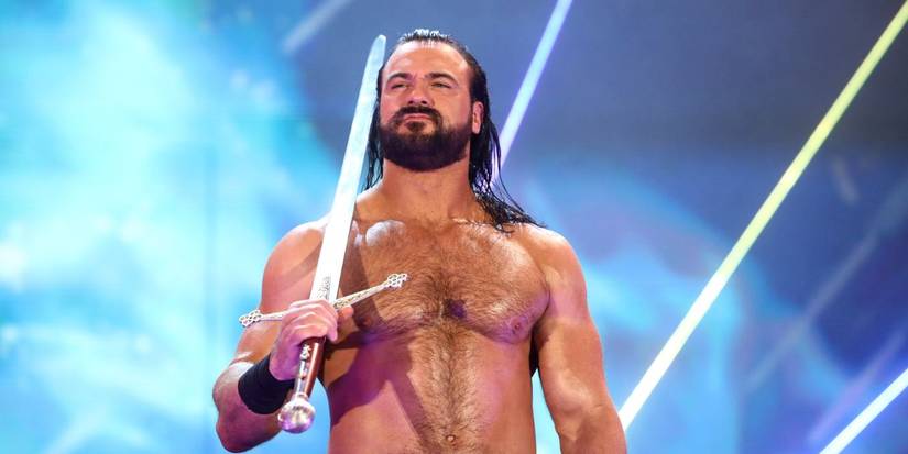 WWE star Drew McIntyre holding a sword over his shoulder.