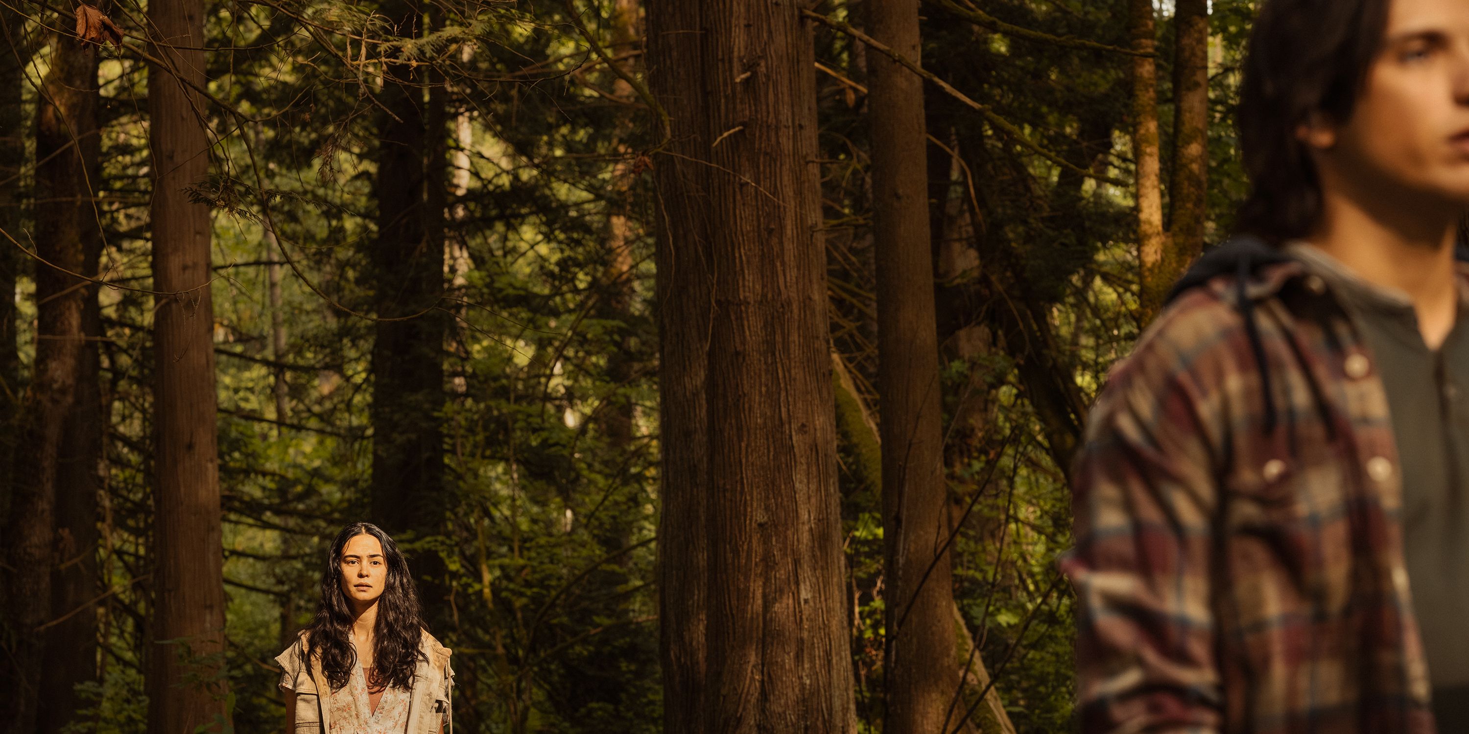 Courtney Eaton as Lottie looking at Kevin Alves as Travis in Yellowjackets season 3