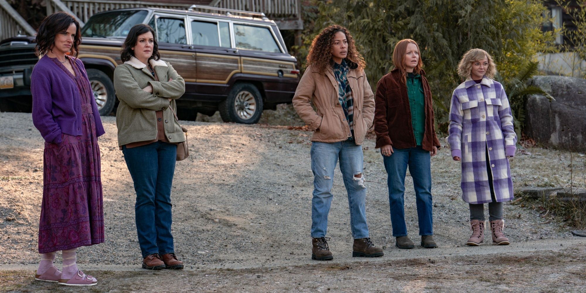 Adult Natalie, Shauna, Taissa, Van, and Misty looking at Lottie&rsquo;s compound in Yellowjackets season 2