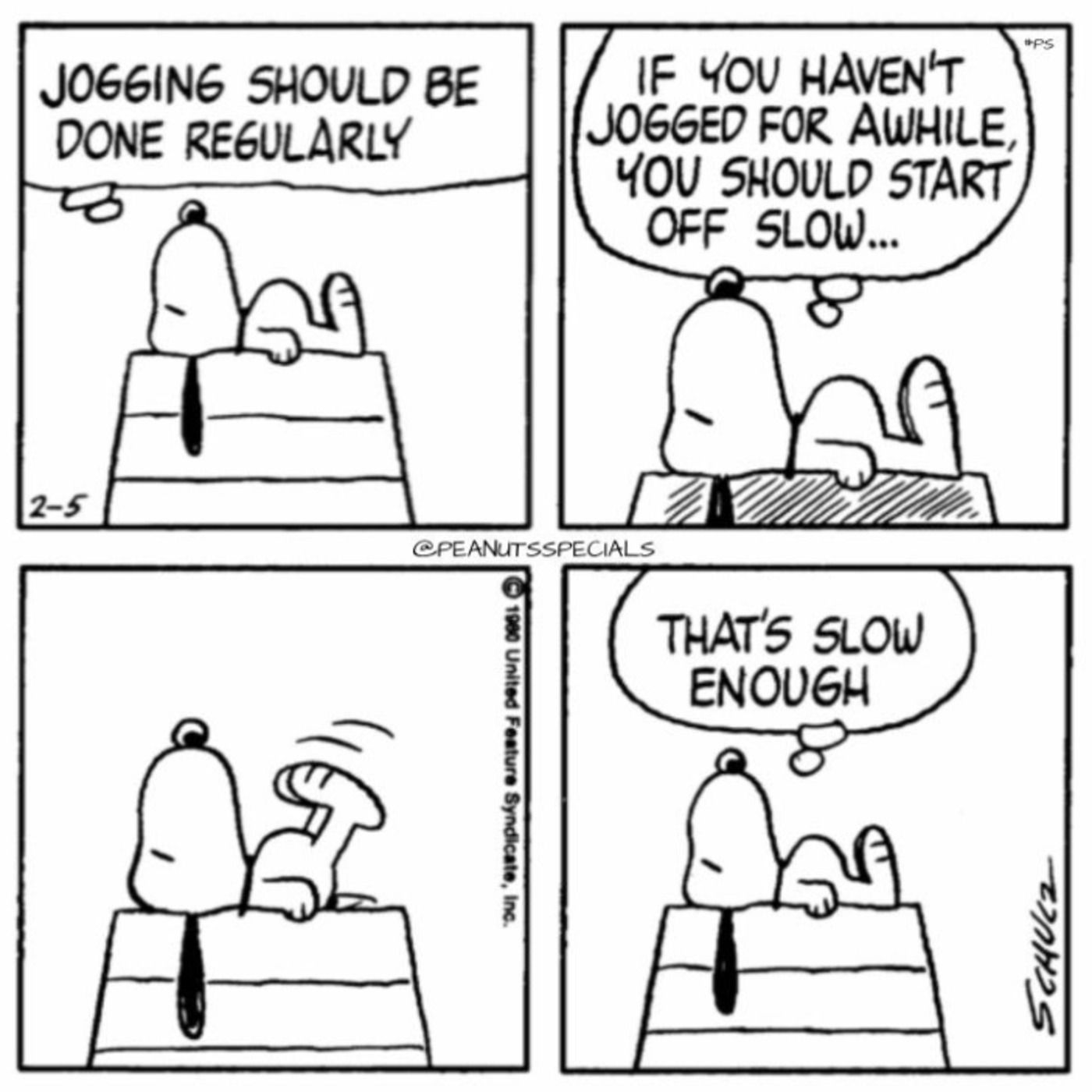 Snoopy laying on his doghouse.