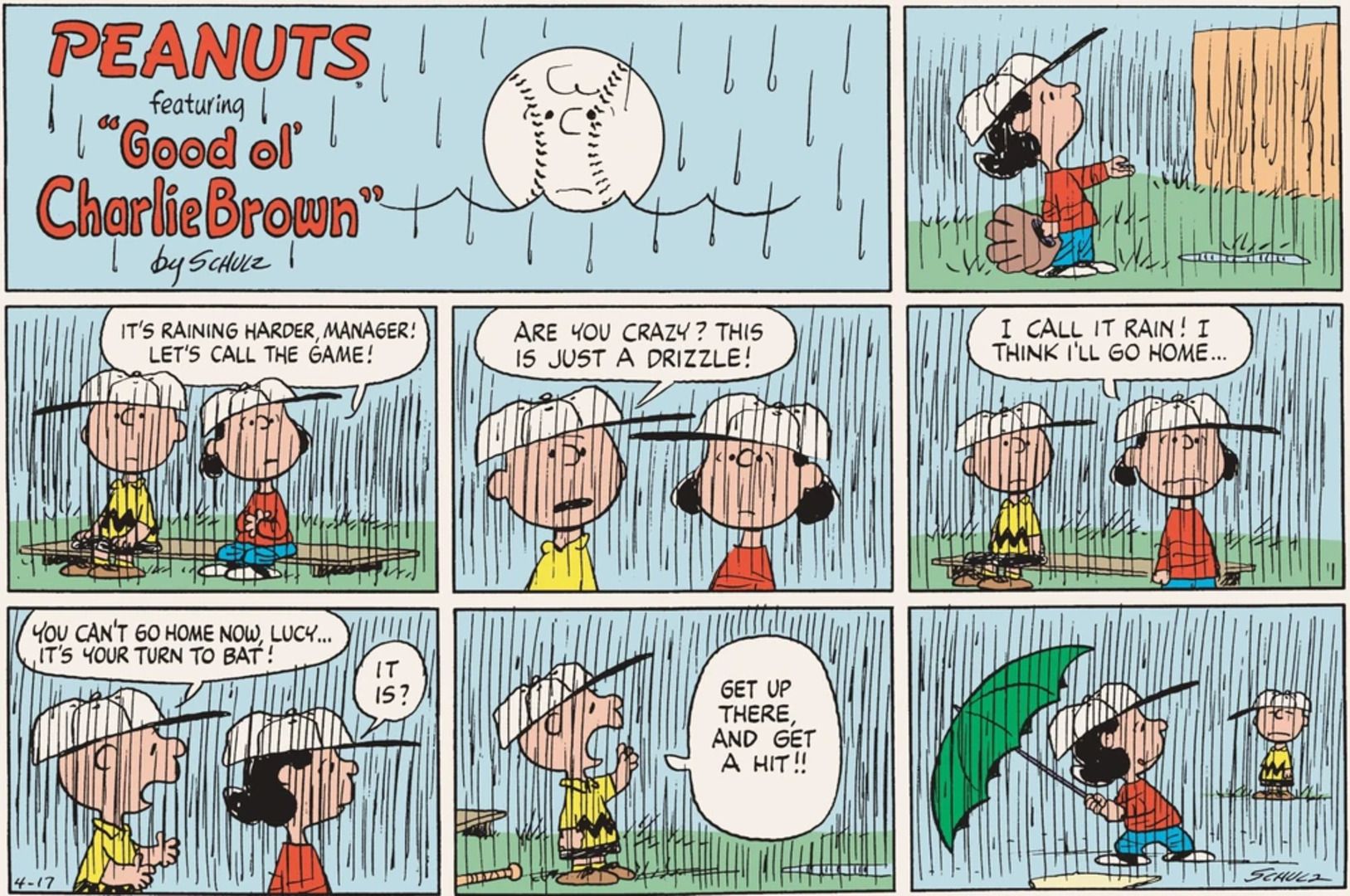 Lucy trying to batter with an umbrella in the rain.