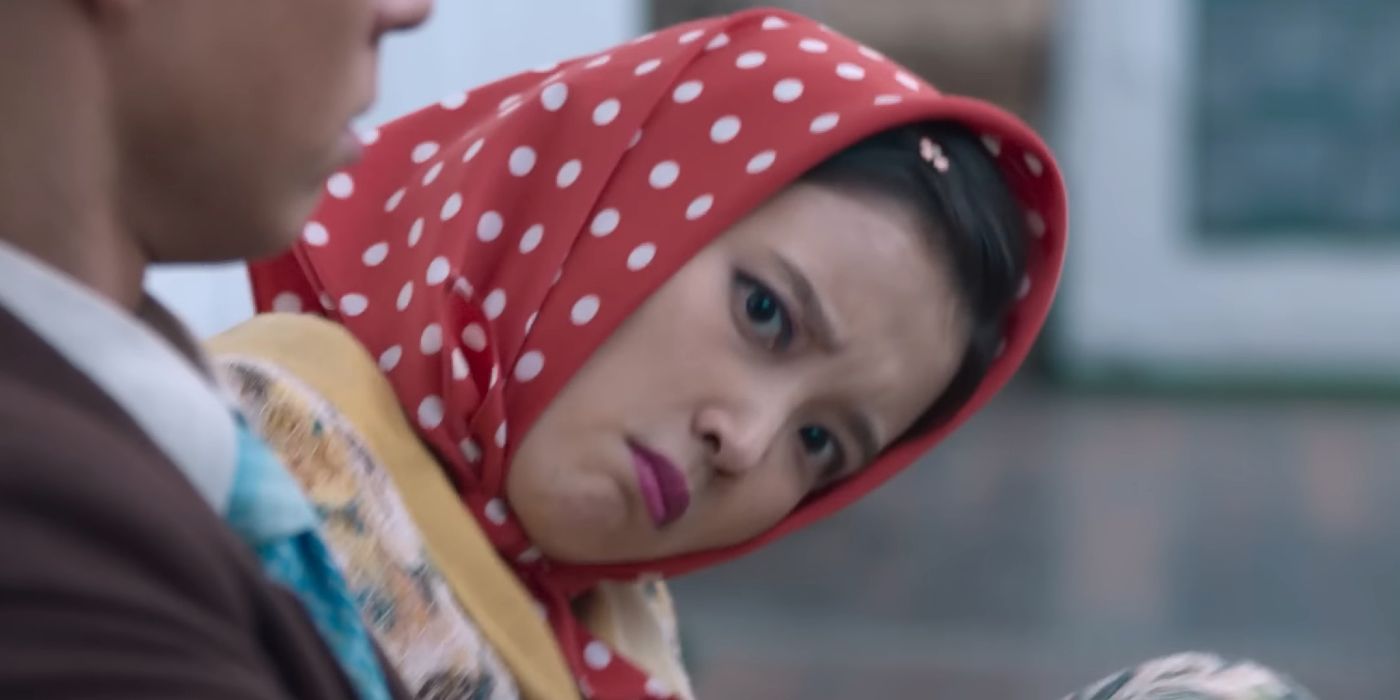 A girl in a head scarf cocking her head in When Life Gives You Tangerines