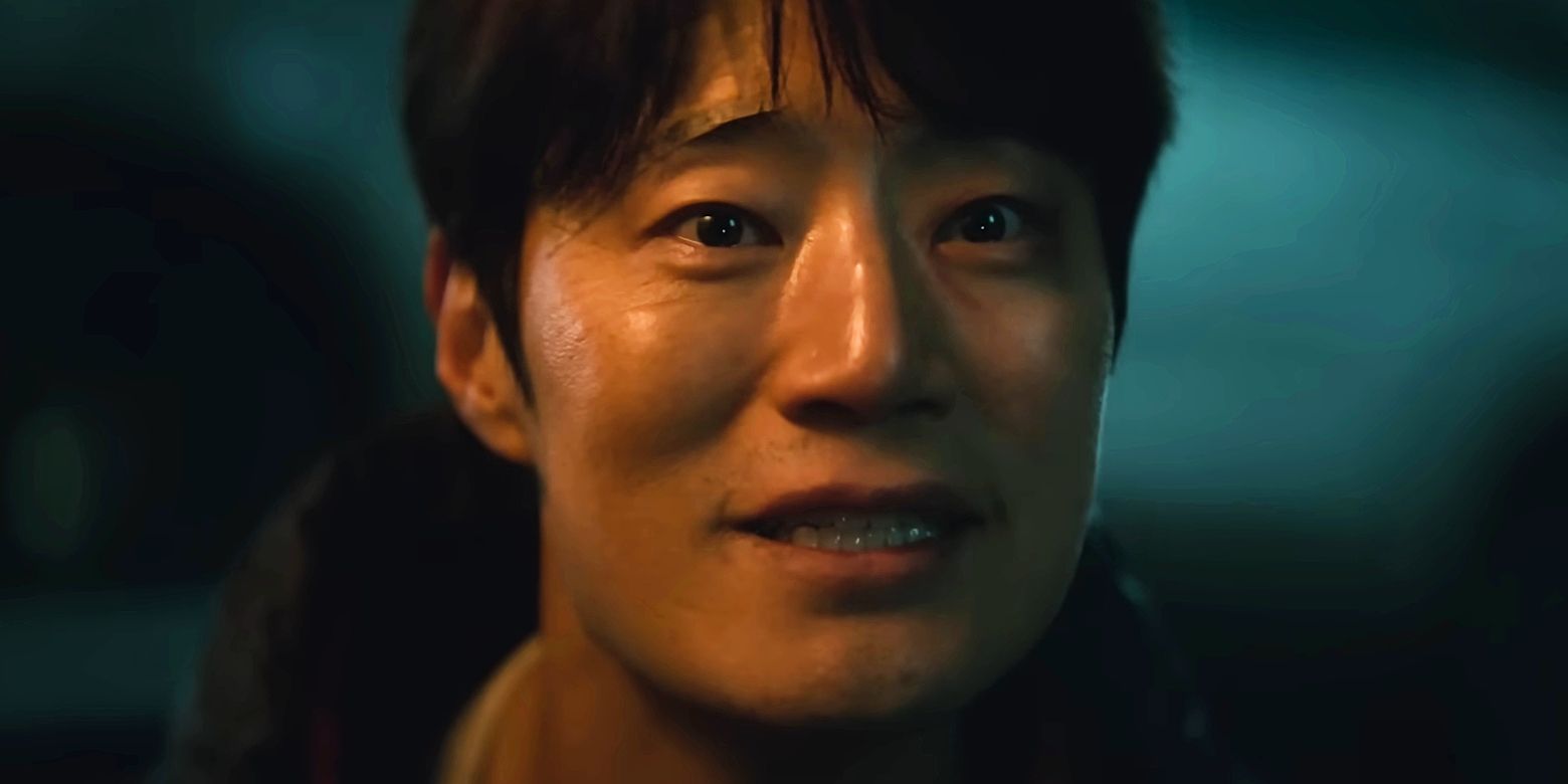 A man smiling awkwardly in close-up in Karma