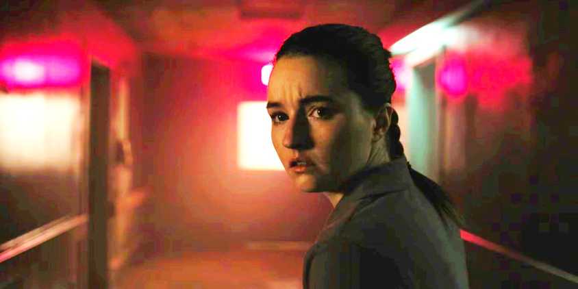 Abby in the hospital corridor looking over her shoulder in The Last of Us season 2