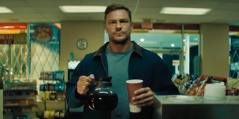 Alan Ritchson as Jack Reacher holding a coffee pot in Reacher season 3