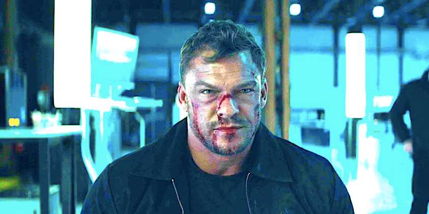 Alan Ritchson's bloodied Reacher sits on a chair and stares in Reacher season 2