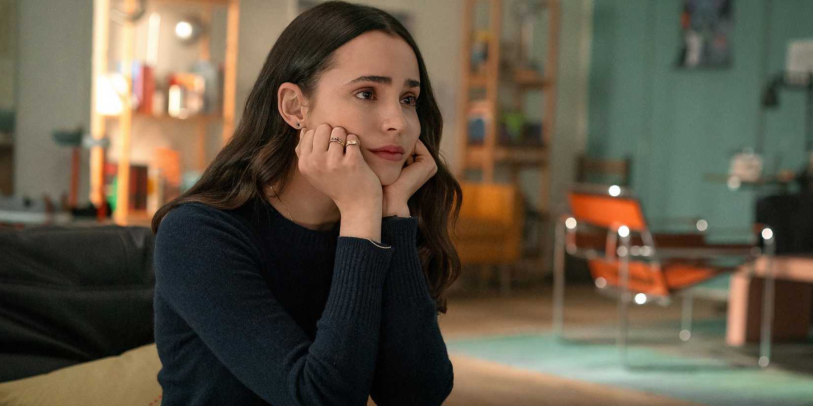 Alex (Sofia Carson) leans her chin on her hands in The Life List