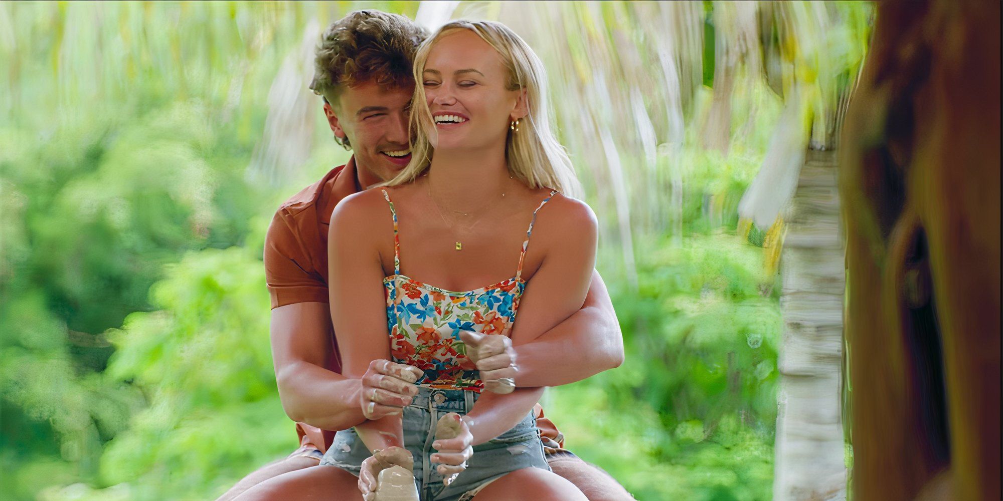 Ashley and Danny laughing while making pottery on their date