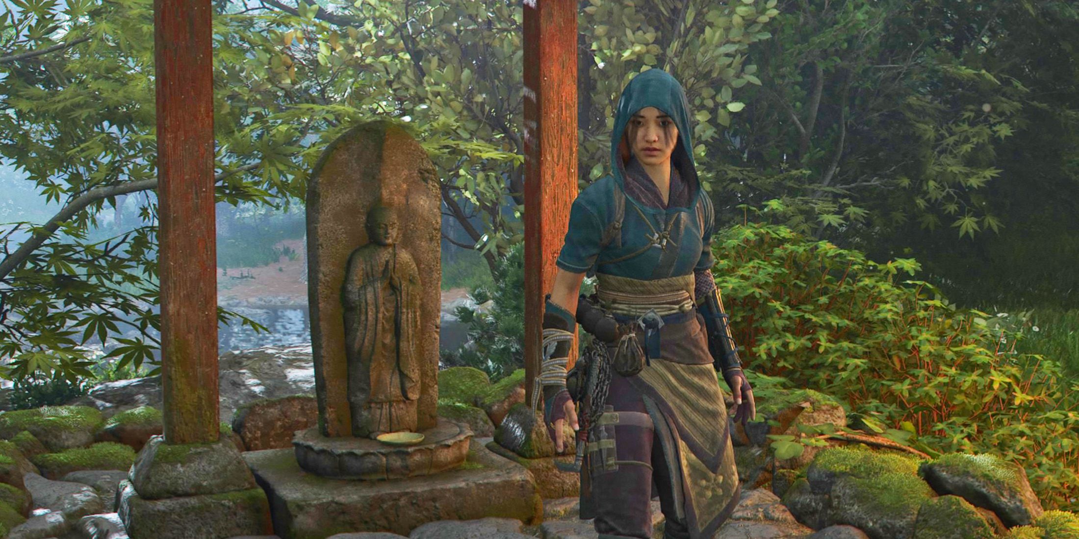 Naoe in front of a Yamashiro Jizo Statue in Assassin’s Creed Shadows