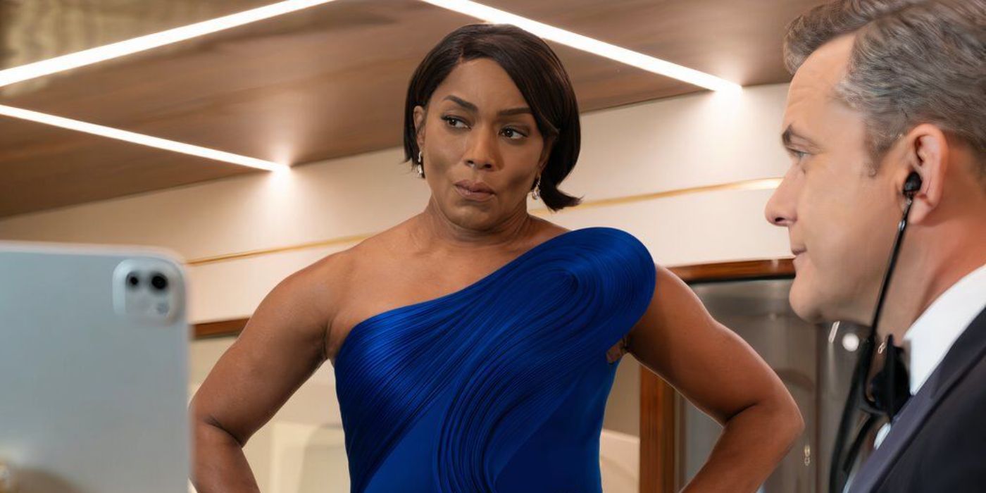 Athena (Angela Bassett) pursing her lips while Doctor Max (Joshua Jackson) listens to a patient in 9-1-1 and Doctor Odyssey Crossover Event First Look Images (1)