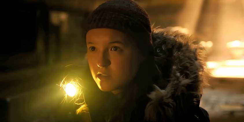 Bella Ramsey as Ellie looking suspiciously while holding a flashlight in The Last of Us season 2