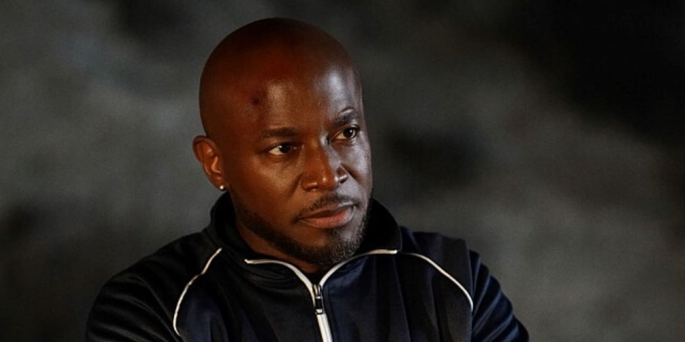 Billy Baker (Taye Diggs) with his arms crossed looking tire in All American.