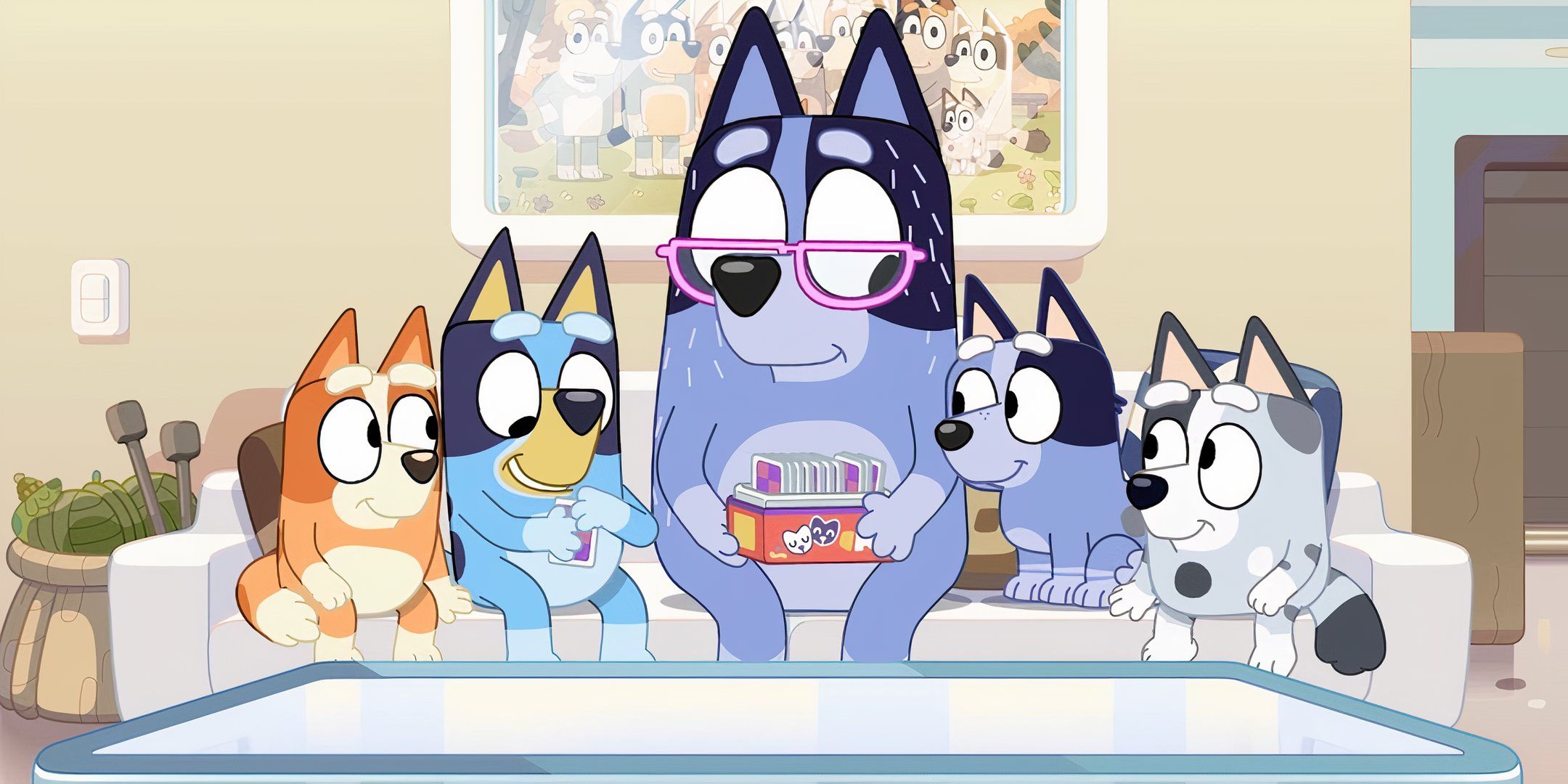 Bluey and Bingo sit on the couch with their Nana and cousins.