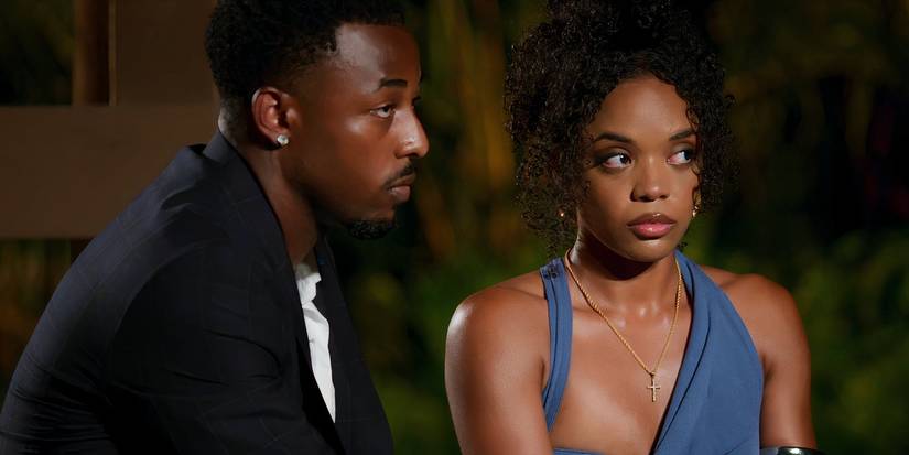 Temptation Island's Brion Whitley and Shante Glover sitting together and looking tense at a bonfire