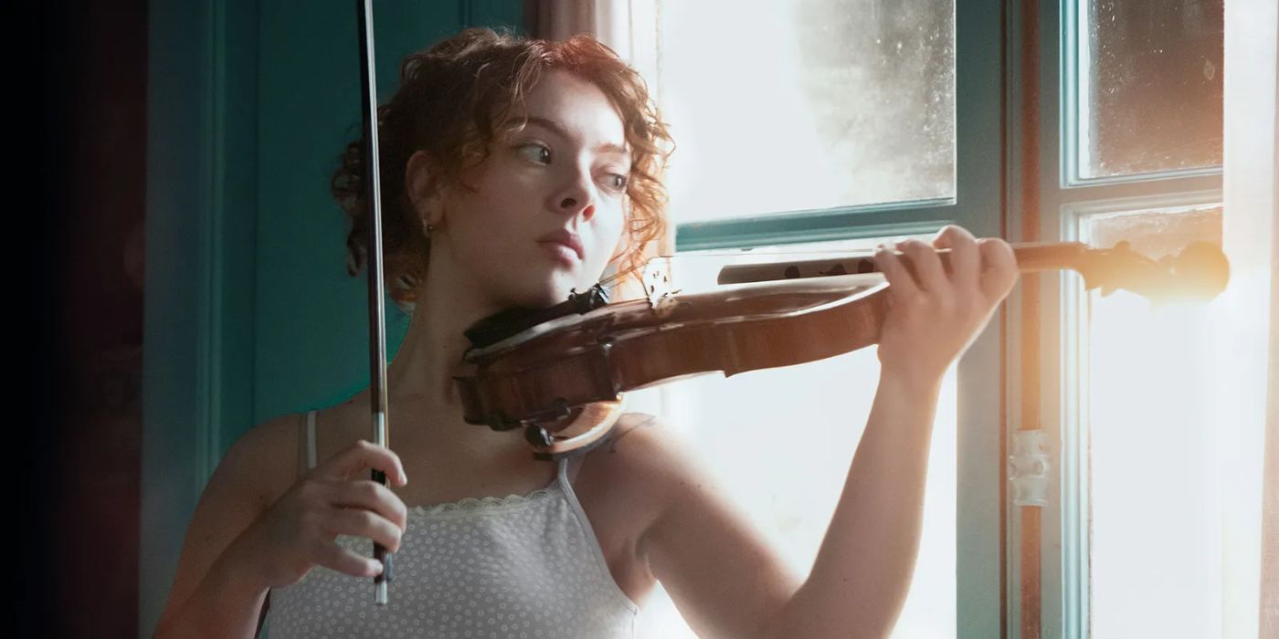 Martina playing the violin in Caught