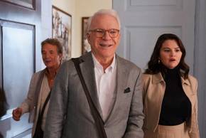 Charles, Mabel and Oliver reacting to something with happy surprise in Only Murders in the Building