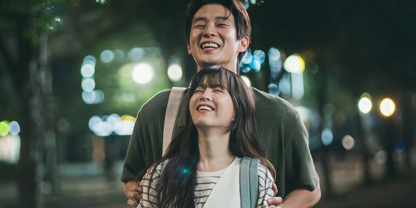 Choi Woo-shik as Ko Gyeom and Park Bo-young as Kim Mu-bee laughing and closing their eyes in Melo Movie