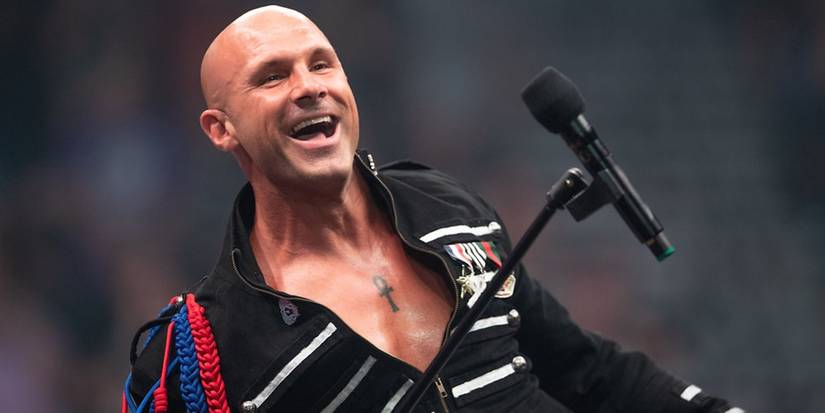 Christopher Daniels makes his entrance for AEW holding a microphone
