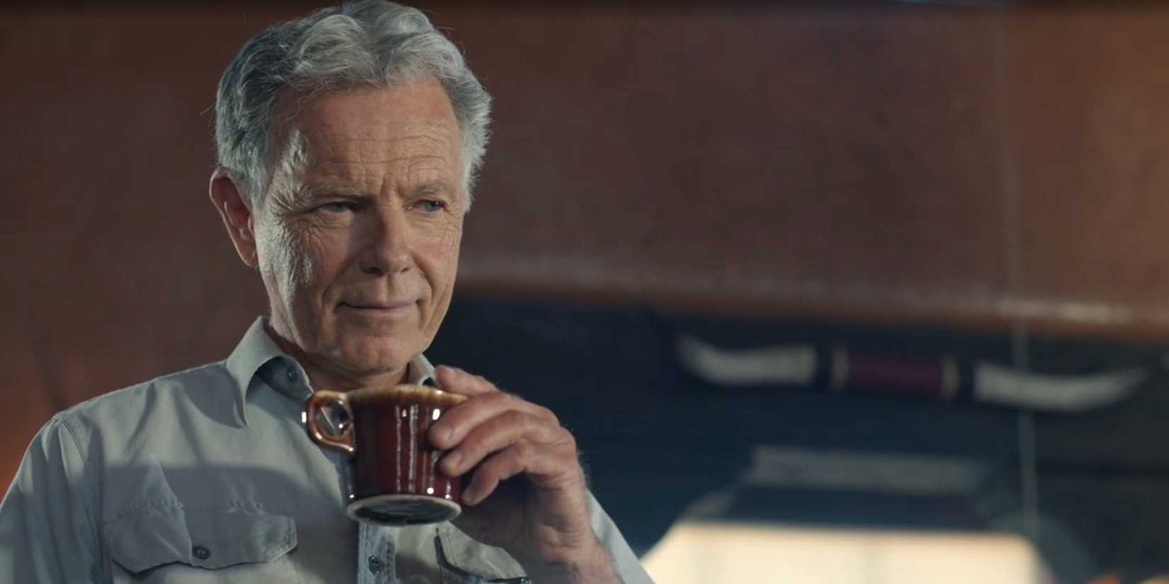 Tom Spenser (Bruce Greenwood) holds a cup of coffee in Dark Winds season 3, episode 3