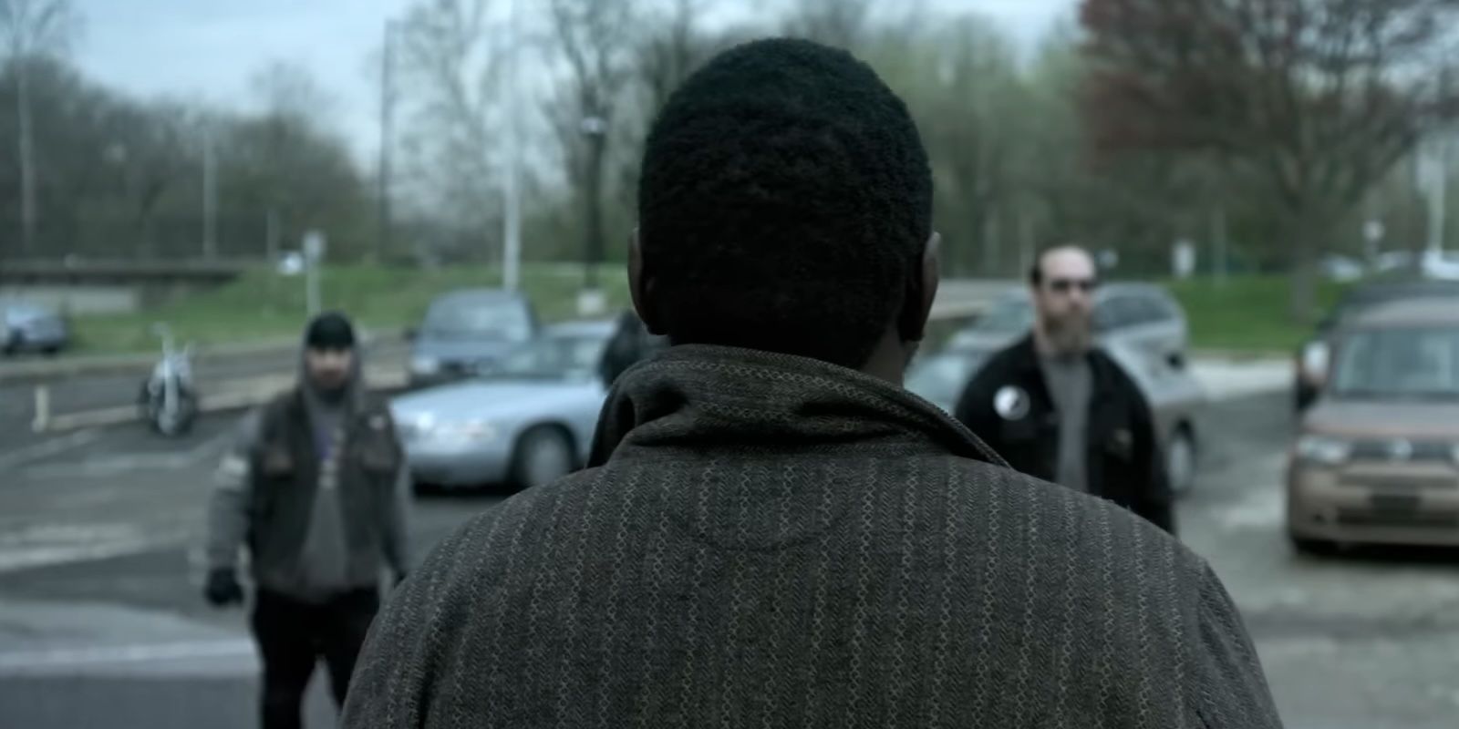 Ray standing in front of a group of killer bikers in Dope Thief