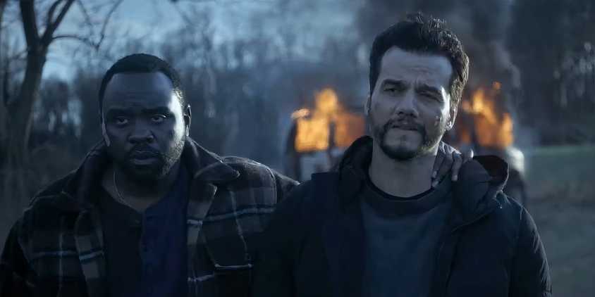 Ray and Manny walking away from a burning van in Dope Thief