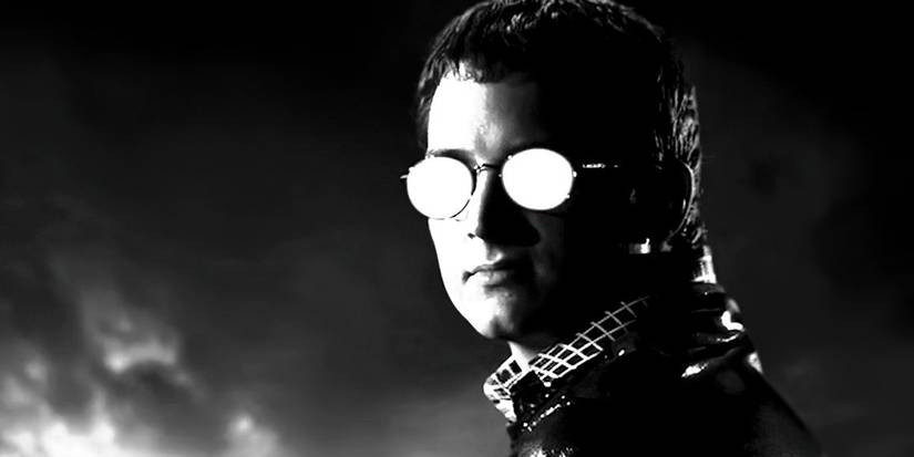 Elijah Wood looking toward the camera with glᴀsses that are whited out in Sin City