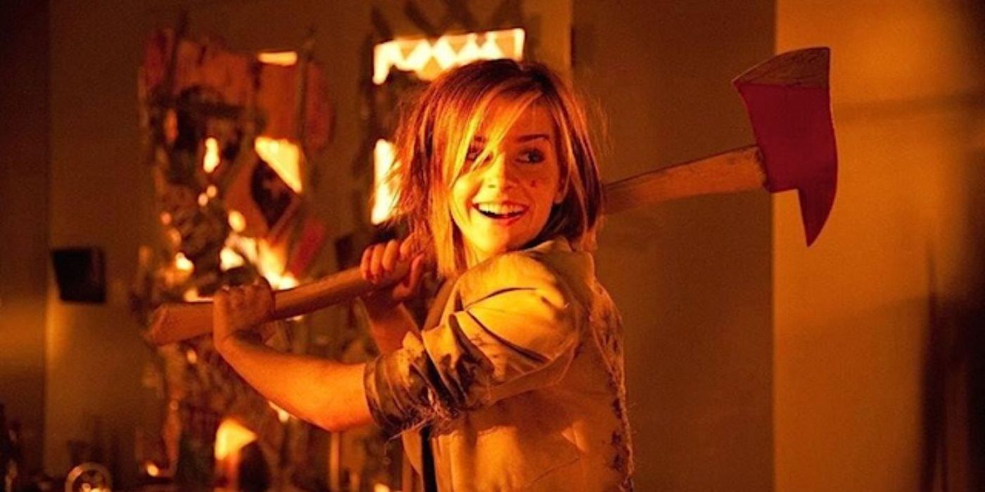 Emma Watson smiling and brandishing an ax in This is the End.