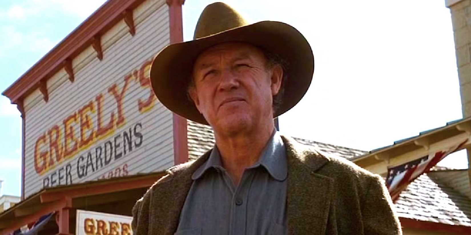 Little Bill Dagget de Gene Hackman fica do lado de fora de uma loja geral em Faldo