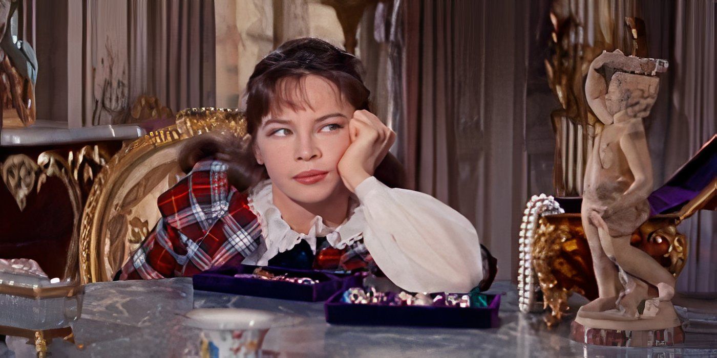 Leslie Caron staring at a statuette in Gigi