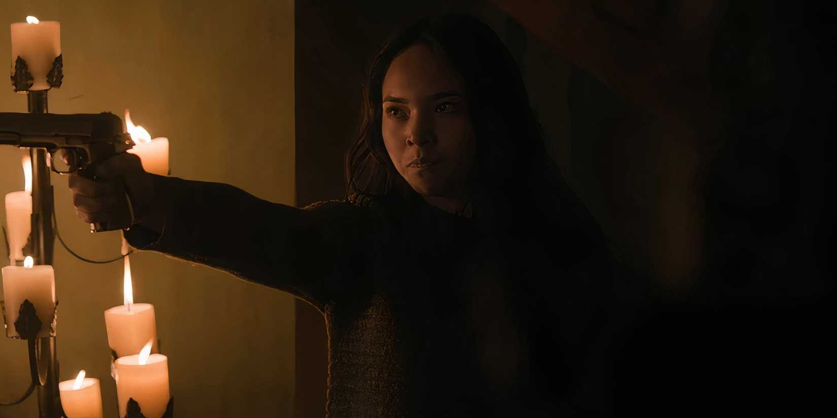 Ginny pointing a gun and looking angry in Dead City season 2