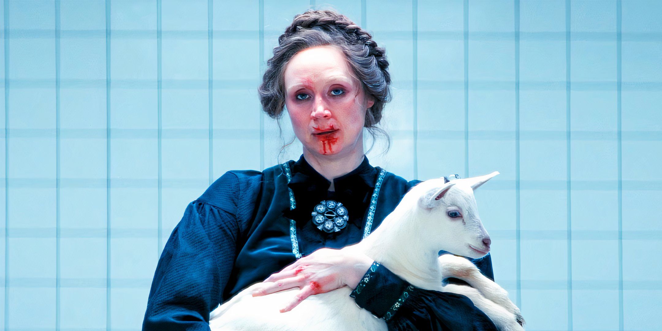 Gwendoline Christie with blood on her face holding a baby goat as Lorne in the Severance season 2 finale