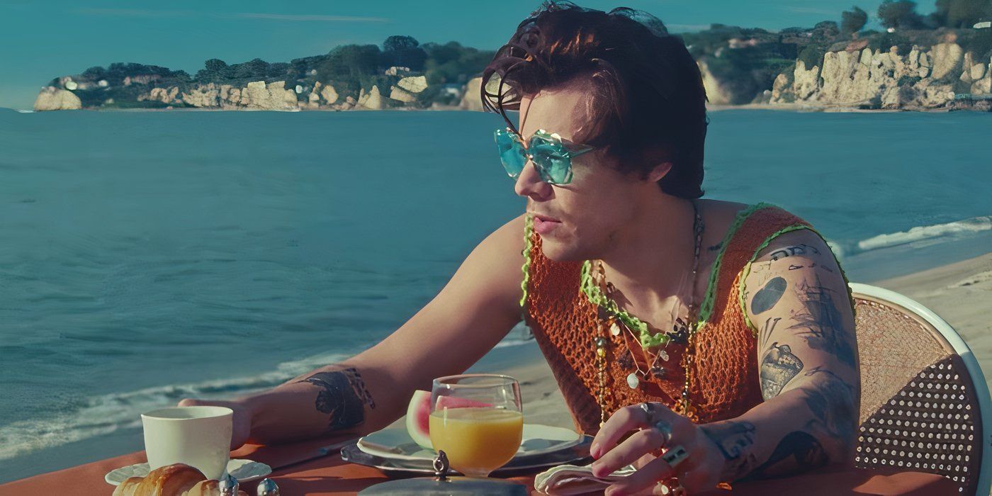 Image of Harry Styles sitting by the ocean in the Watermelon Sugar music video