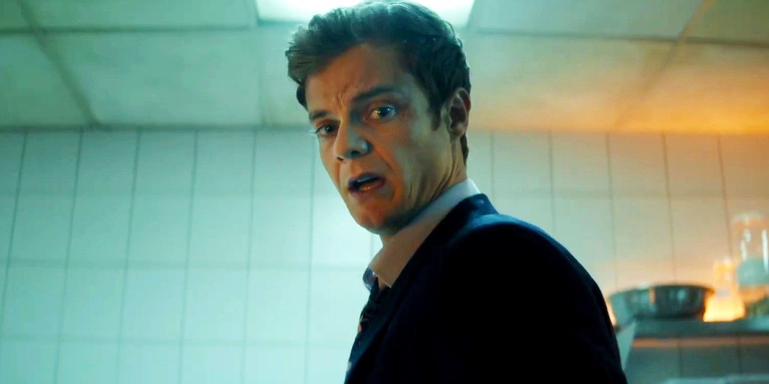 Jack Quaid looking down at something in horror in Novocaine