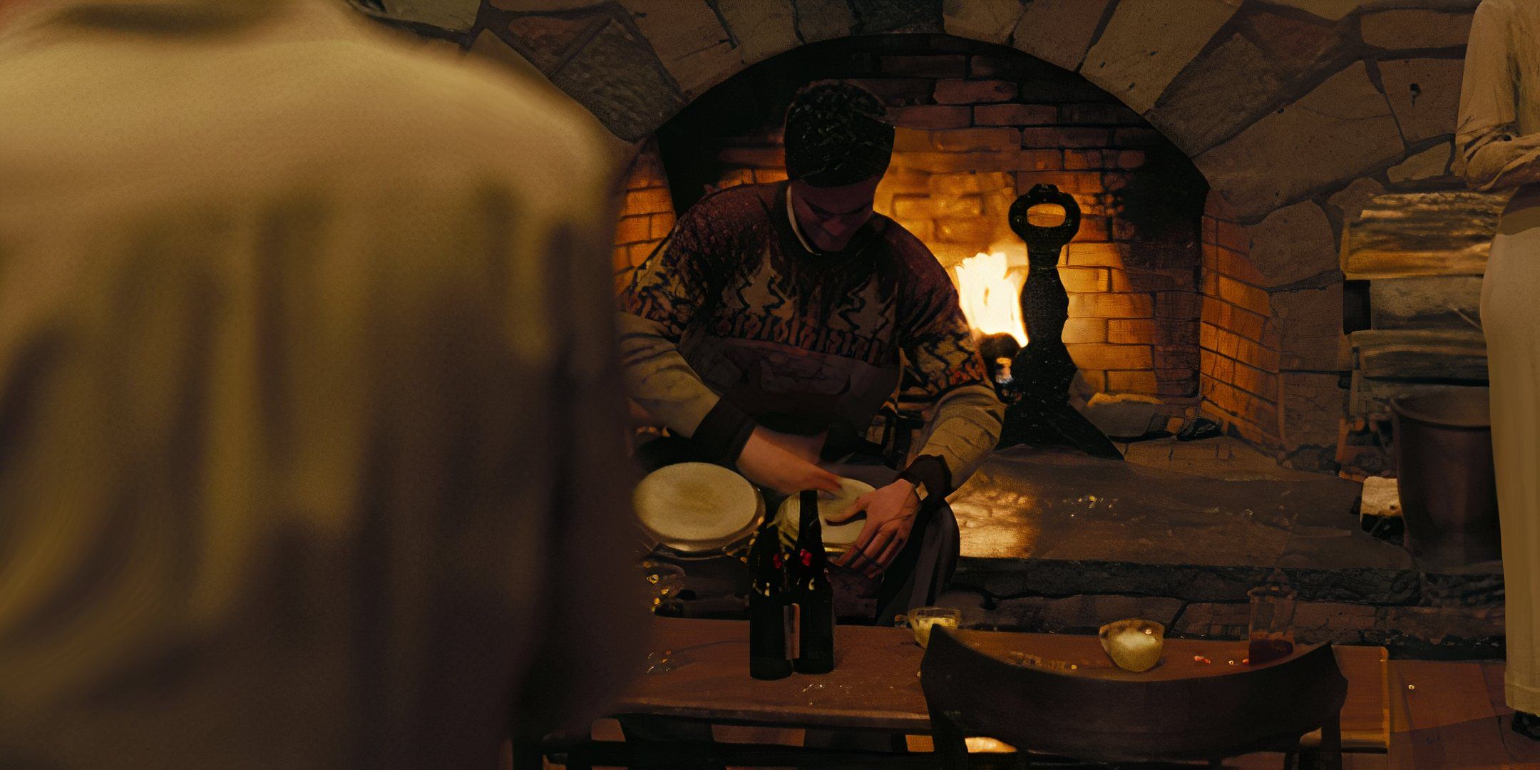 Jack Quaid playing the bongos as Richard Feynman in Oppenheimer